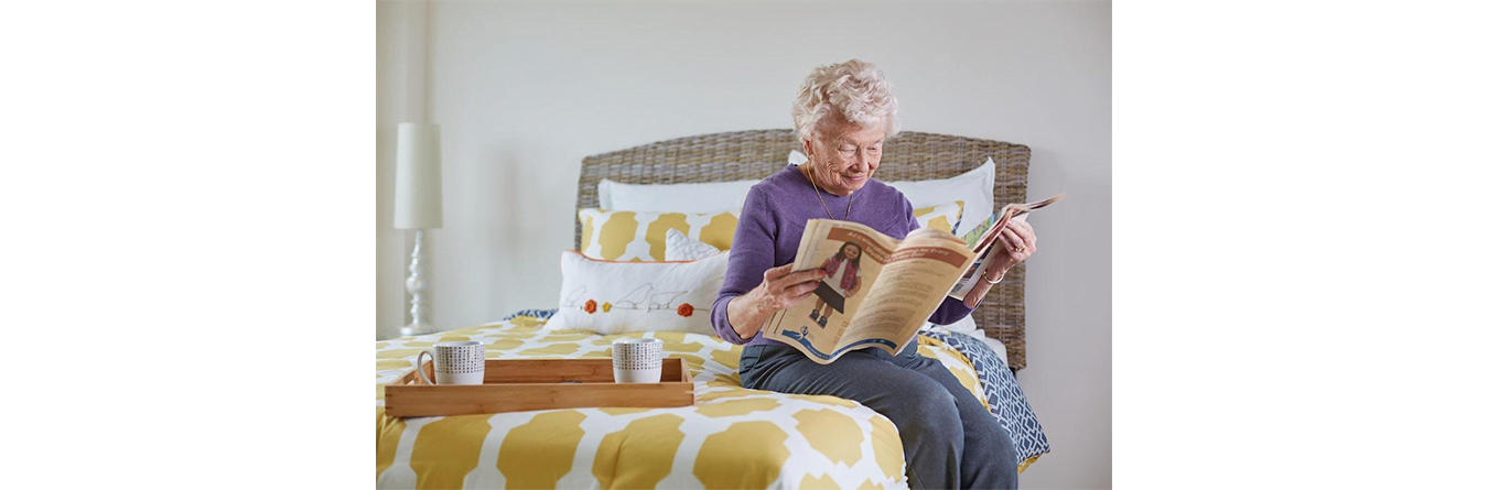 elder woman reading the paper