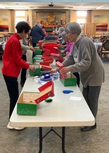 Holly Creek residents fill gift boxes as a part of Operation Christmas Child