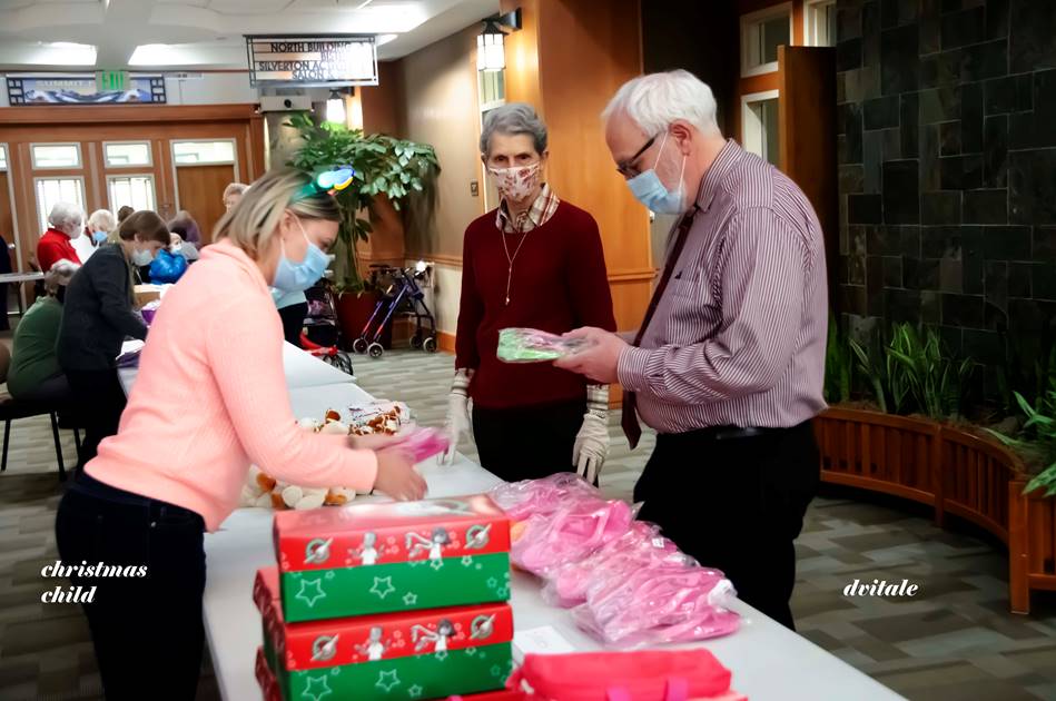 Director of Community Life April Henderson (left), Resident Henrietta Smith (middle) and Chaplain Jim Kok (right) help assemble Operation Christmas Child boxes at Holly Creek. Photo credit: Holly Creek Life Plan Community