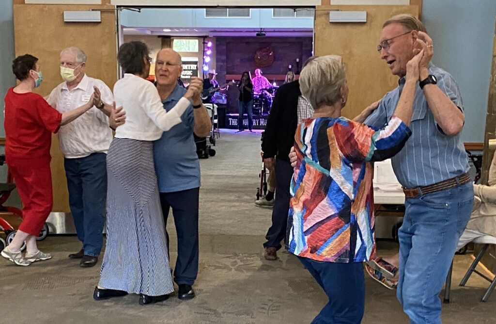 Couples swing dance to songs by the Country Music Project