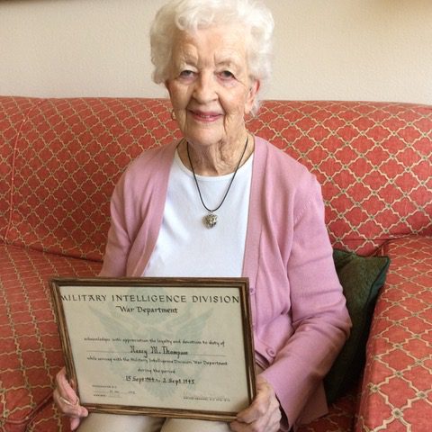 Nancy Tipton, holding a plaque in honor of her service during & after WWII.