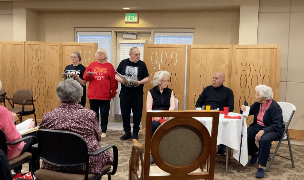 Cast members practice for “Robots Gone Rogue” with robots on the left and diners on the right.