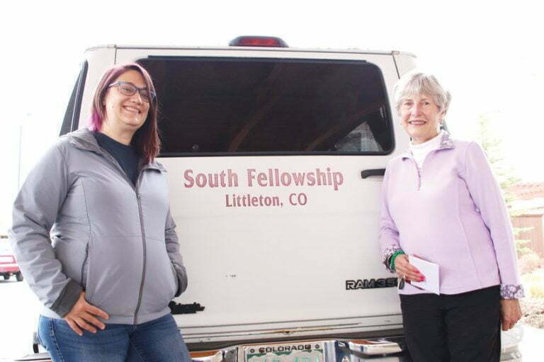 Erin Young, director of the South Fellowship Food Bank, left, and Vee Henderson, a Holly Creek Retirement Community resident, stand together during an April 15 pickup of donated food items at the retirement community in Centennial.