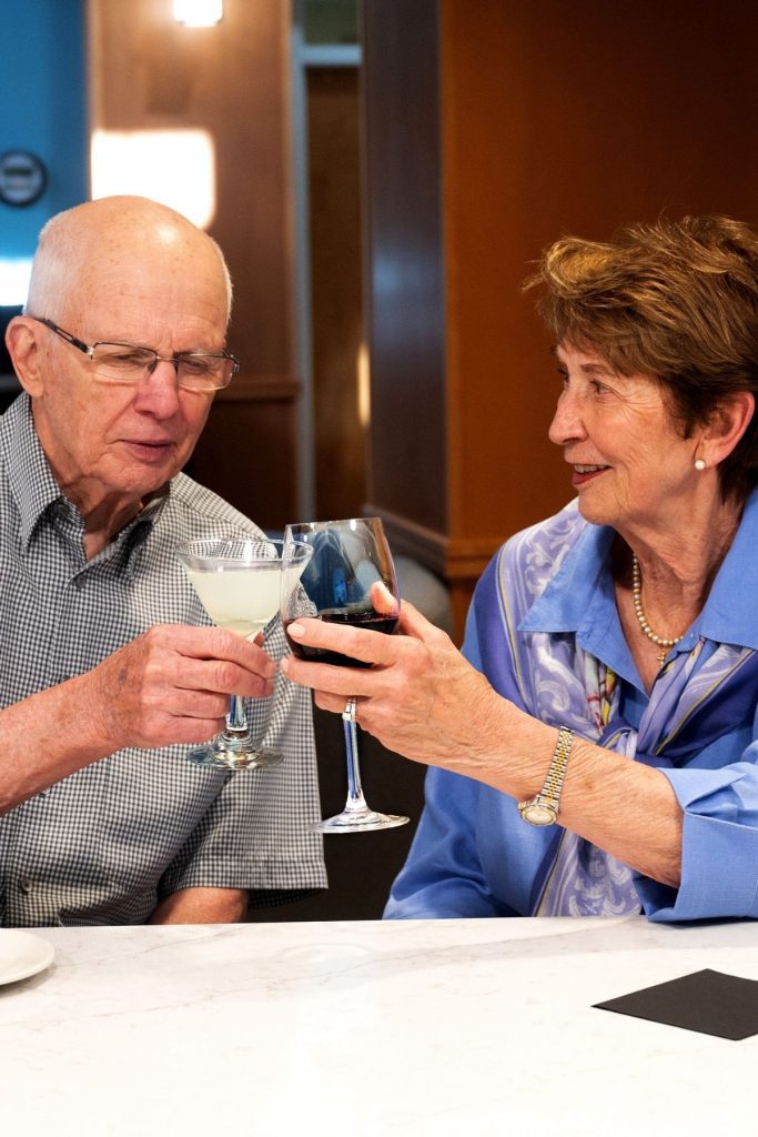 residents clanking wine glasses portrait