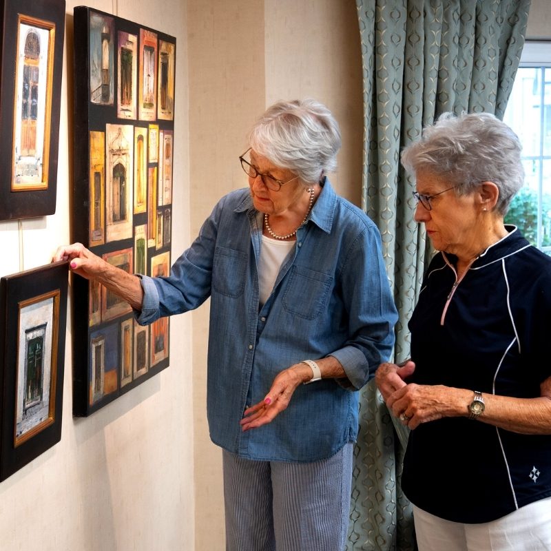 woman looking at art on wall square