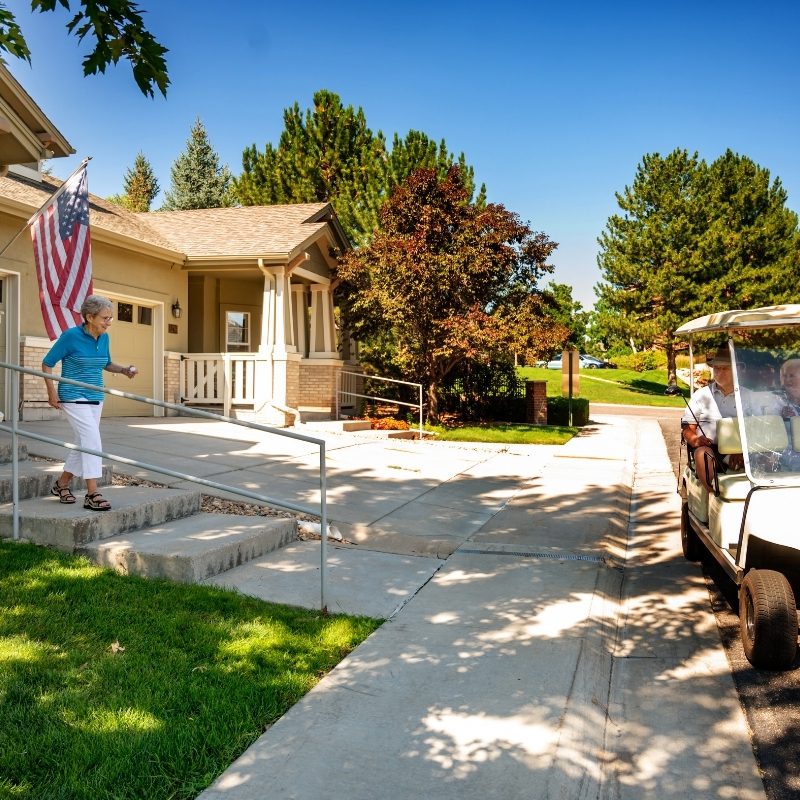 woman walks outside to meeting friends in golf cart square