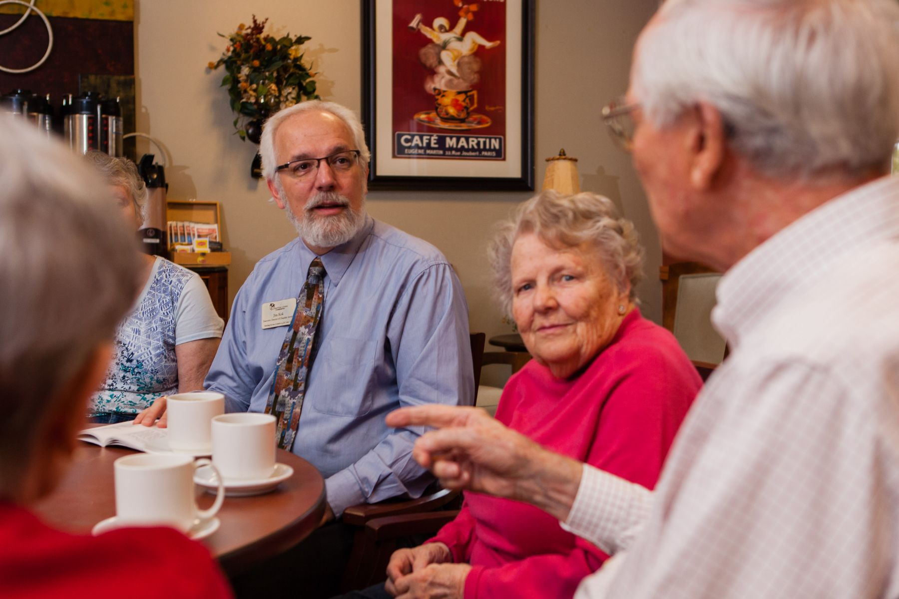 chaplain talking with group of residents landscape