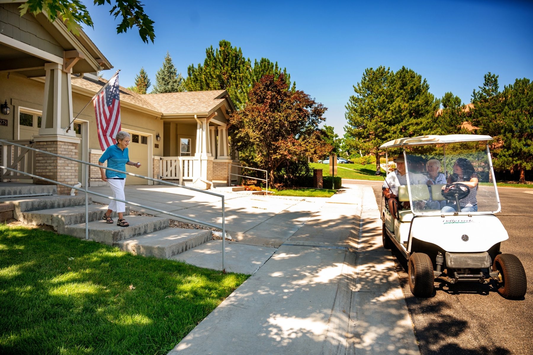 woman walks outside to meeting friends in golf cart landscape