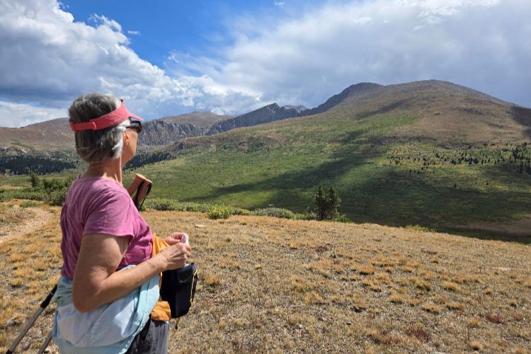 holly creek resident enjoys mountain view on hike