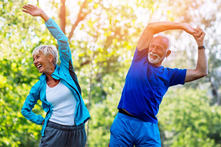senior couple stretching outside