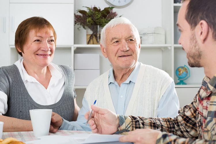 older couple talking with a real estate agent older couple talking with a real estate agent