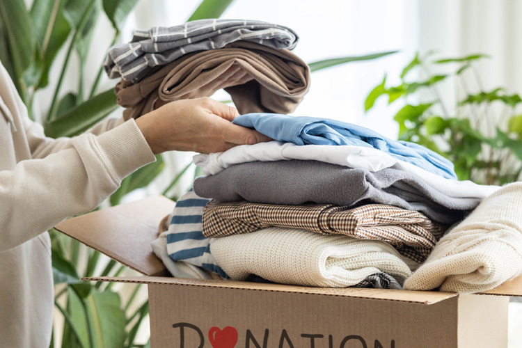 holly creek putting clothes in donation box holly creek putting clothes in donation box