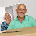 holly creek senior couple with moving boxes