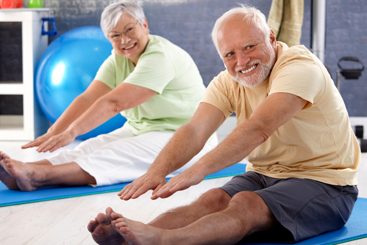 holly creek senior man and woman stretching in an exercise class holly creek senior man and woman stretching in an exercise class